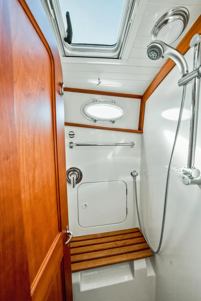 Slide: The Image of Shower area in 2008 Hinckley Talaria 44 yacht with wooden accents and skylight. - 12