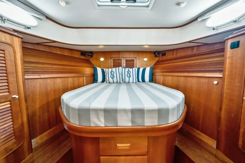 Slide: The Image of Luxurious 2008 Hinckley Talaria 44 yacht cabin with elegant wood finish and cozy bed. - 13