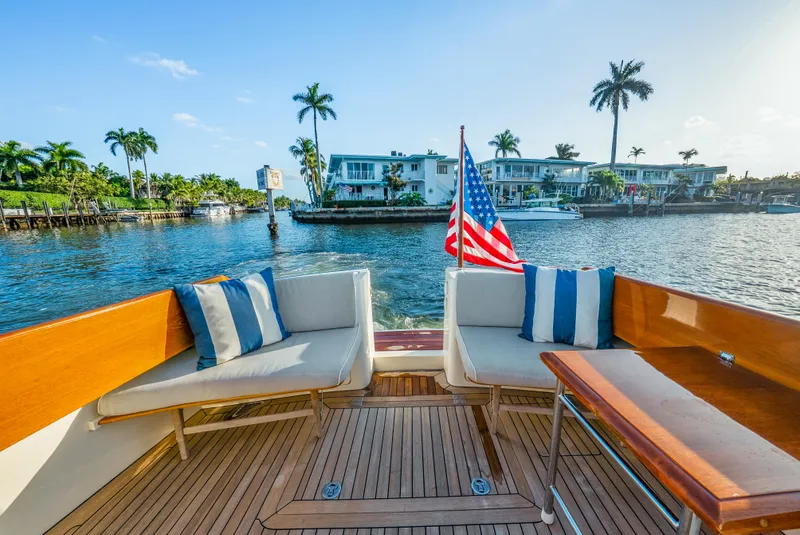 Slide: The Image of Hinckley Talaria 44 yacht deck with seating, American flag, waterfront view, 2008 model. - 15