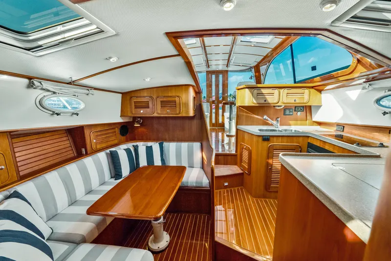 Slide: The Image of Luxurious interior of 2008 Hinckley Talaria 44 yacht with wood finishes and striped seating. - 7