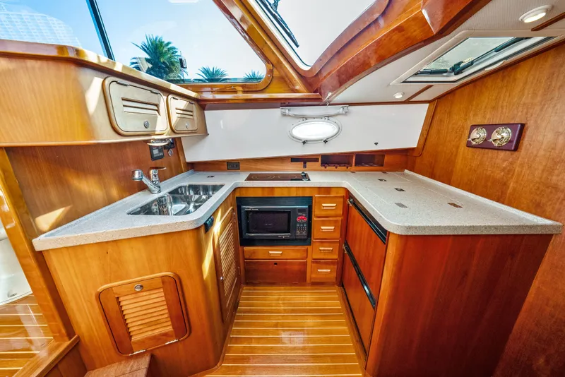 Slide: The Image of Luxurious 2008 Hinckley Talaria 44 yacht interior with elegant wooden kitchen design. - 8
