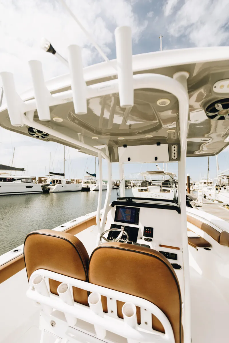 Slide: The Image of 2019 Sea Pro 259 Center Console boat docked at marina, featuring modern helm and seating. - 11