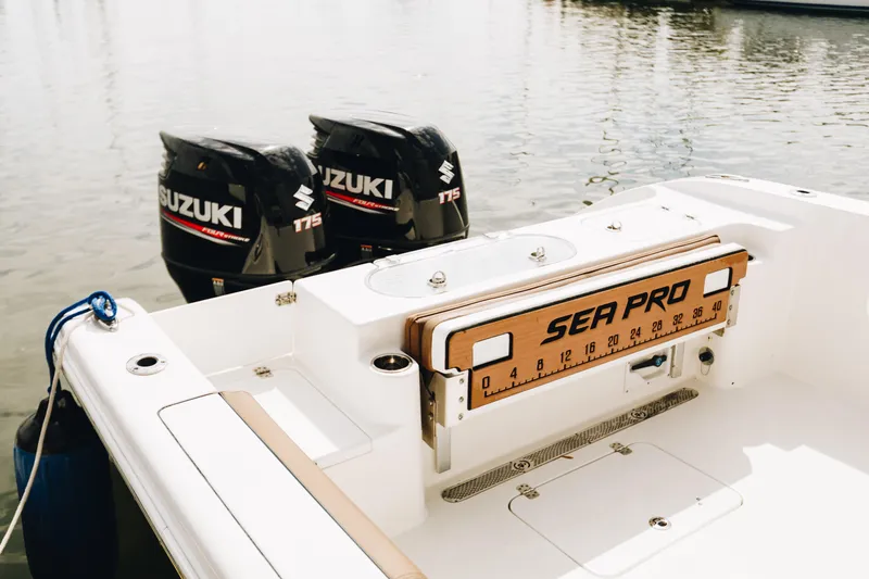 Slide: The Image of 2019 Sea Pro 259 Center Console boat with dual Suzuki 175 engines on calm water. - 4