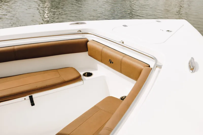 Slide: The Image of 2019 Sea Pro 259 Center Console boat with tan seating, docked on calm water. - 5