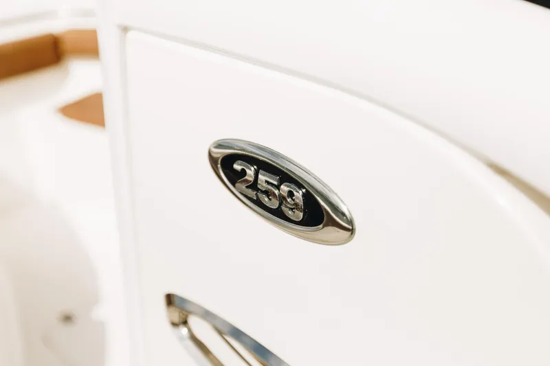 Slide: The Image of 2019 Sea Pro 259 Center Console emblem on white surface. - 7