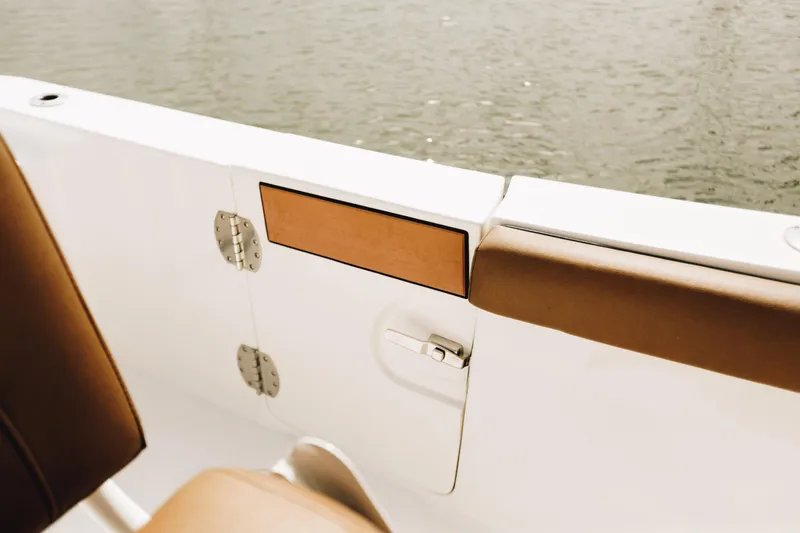 Slide: The Image of 2019 Sea Pro 259 Center Console boat interior with brown seating and water view. - 8