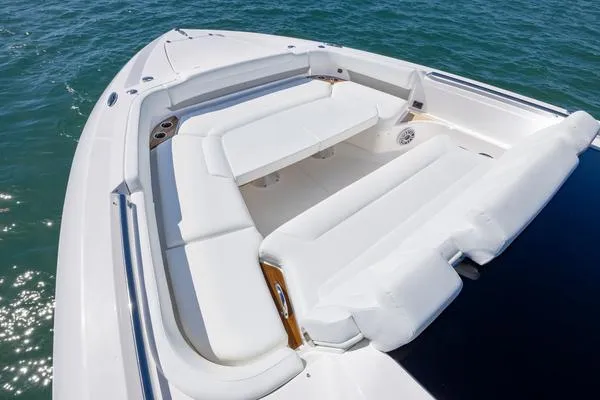 Slide: The Image of 2025 Tiara Yachts 56 LS luxury boat with spacious white seating on open water. - 12