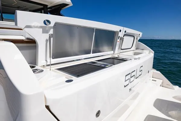 Slide: The Image of 2025 Tiara Yachts 56 LS luxury yacht with sleek outdoor kitchen setup. - 19