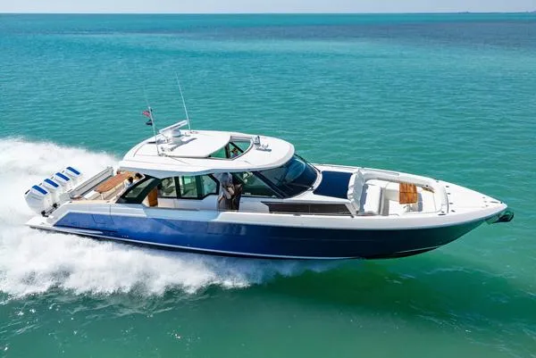 Slide: The Image of 2025 Tiara Yachts 56 LS cruising on clear blue ocean waters. - 2