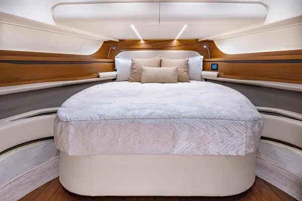 Slide: The Image of Luxurious bedroom interior of 2025 Tiara Yachts 56 LS with elegant wood accents. - 20