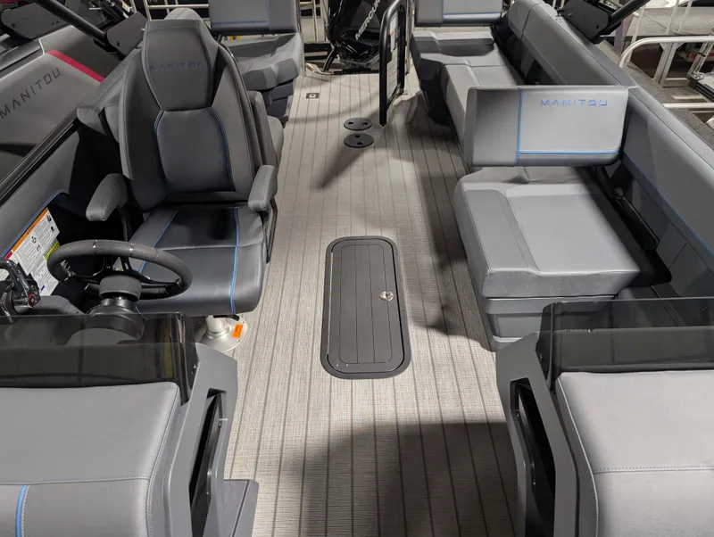 Slide: The Image of 2025 Manitou Explore boat interior with modern seating and steering wheel. - 13