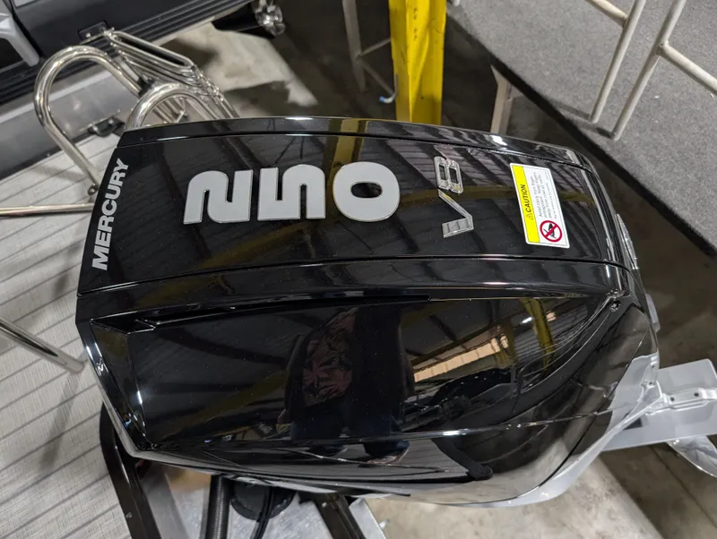 Slide: The Image of 2025 Manitou Explore with Mercury V8 engine, sleek black design in a showroom setting. - 4