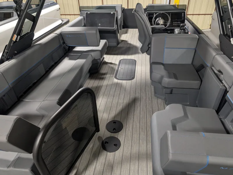 Slide: The Image of 2025 Manitou Explore boat interior with modern seating and steering console. - 5