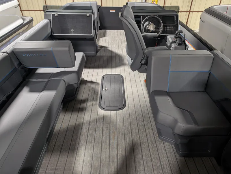 Slide: The Image of 2025 Manitou Explore boat interior with modern seating and steering console. - 6