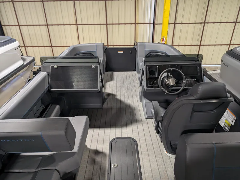Slide: The Image of 2025 Manitou Explore boat interior with modern seating and steering console. - 7