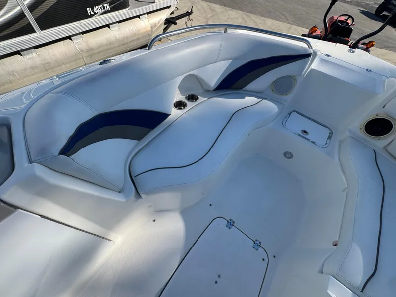Slide: The Image of 2012 Hurricane SunDeck Sport 200 OB boat interior with white and blue seating. - 10