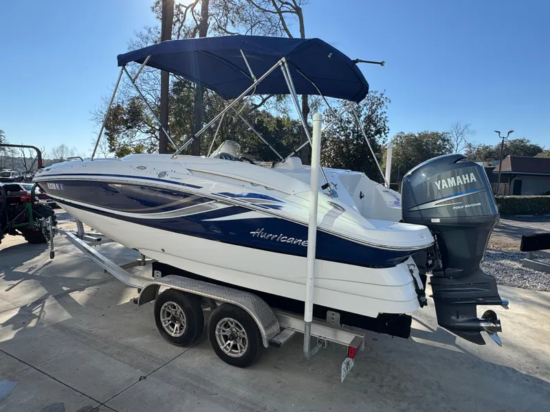 Slide: The Image of 2012 Hurricane SunDeck Sport 200 OB boat on trailer with Yamaha outboard motor. - 13