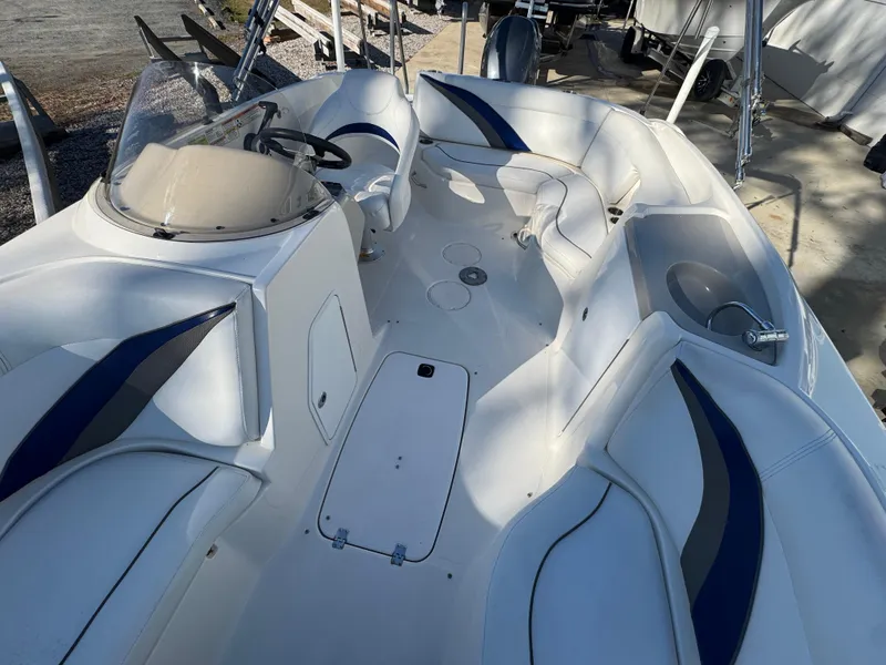 Slide: The Image of 2012 Hurricane SunDeck Sport 200 OB boat interior with white and blue seating. - 17