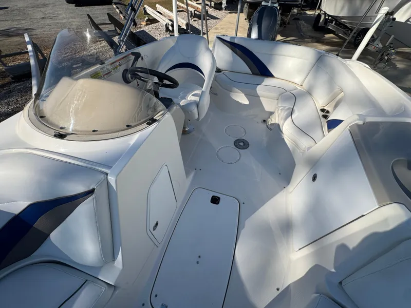 Slide: The Image of 2012 Hurricane SunDeck Sport 200 OB boat interior with seating and steering console. - 4