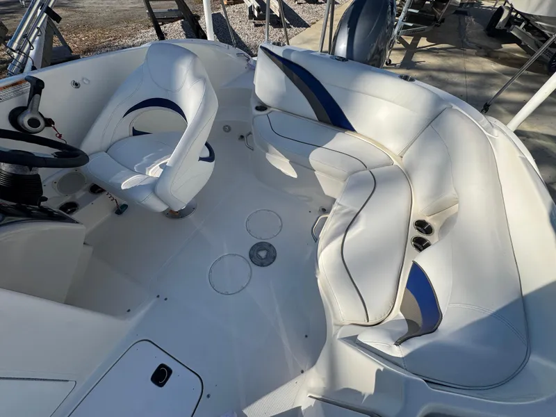 Slide: The Image of 2012 Hurricane SunDeck Sport 200 OB boat interior with white seating and steering console. - 5