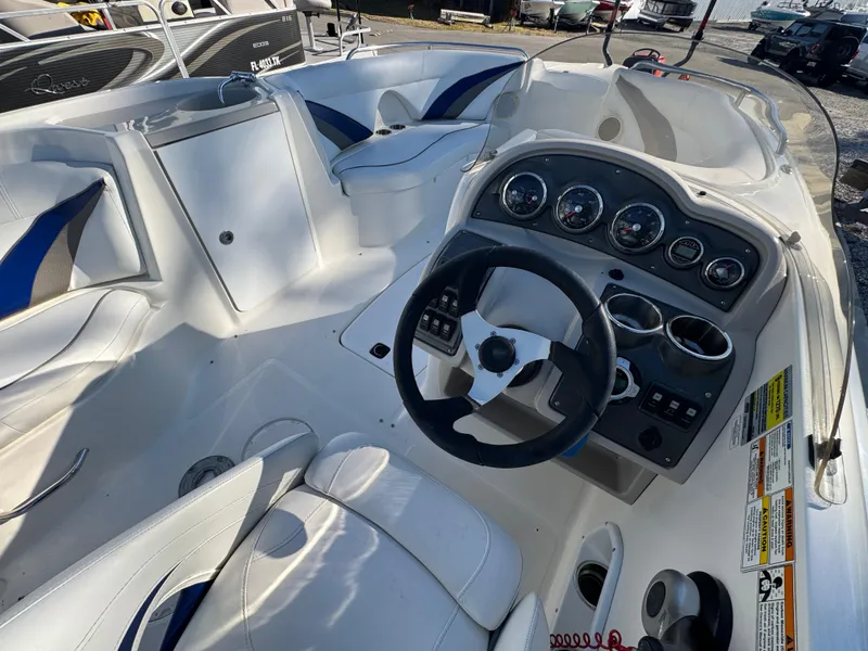 Slide: The Image of 2012 Hurricane SunDeck Sport 200 OB boat interior with steering wheel and dashboard controls. - 6