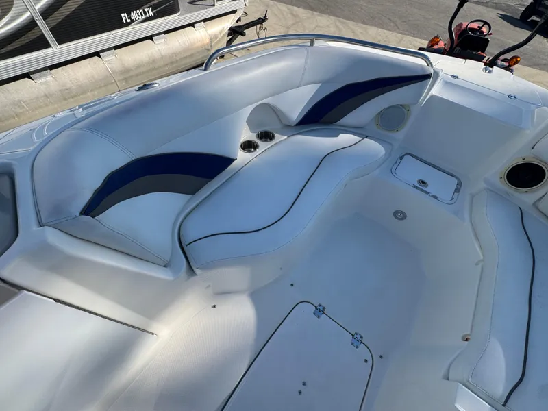 Slide: The Image of 2012 Hurricane SunDeck Sport 200 OB boat interior with white and blue seating. - 9