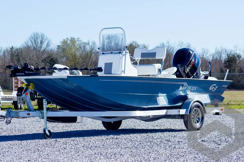 Slide: The Image of 2025 G3 Bay 19 GX boat on trailer, parked outdoors on gravel. - 1