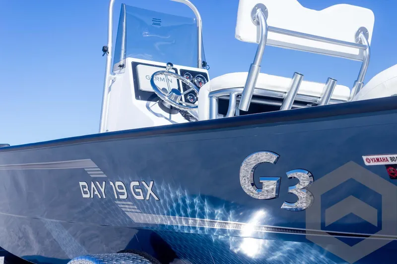 Slide: The Image of 2025 G3 Bay 19 GX boat, sleek design, blue exterior, console view. - 10