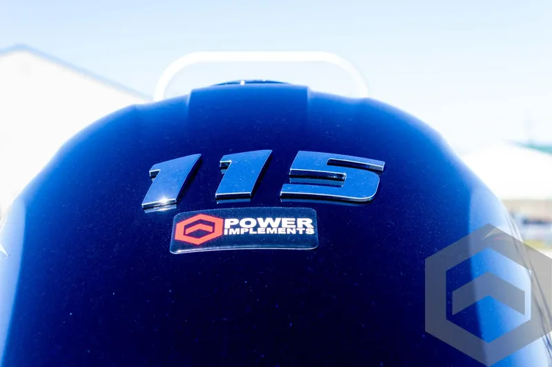 Slide: The Image of Close-up of 2025 G3 Bay 19 GX engine cover with '115' and 'Power Implements' logo. - 12