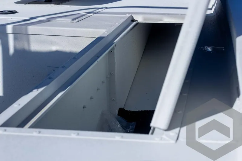 Slide: The Image of 2025 G3 Bay 19 GX boat storage compartment, open lid, interior view. - 18