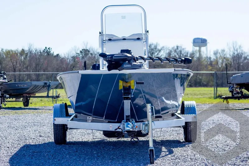 Slide: The Image of 2025 G3 Bay 19 GX boat on trailer, parked outdoors on gravel. - 2