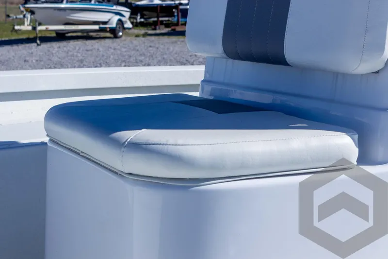 Slide: The Image of White cushioned seat on 2025 G3 Bay 19 GX boat, with other boats in background. - 20