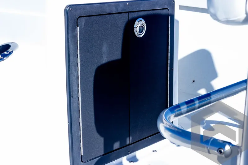 Slide: The Image of 2025 G3 Bay 19 GX boat storage compartment with sleek black door and chrome handle. - 23