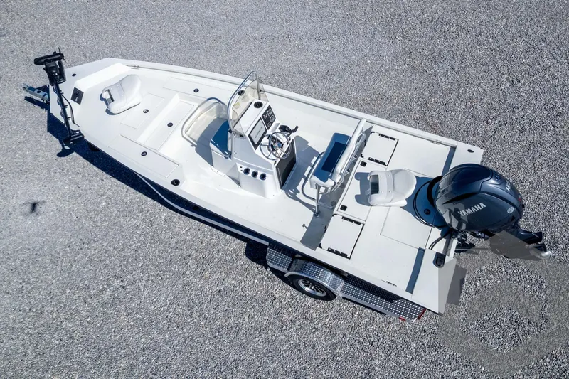 Slide: The Image of 2025 G3 Bay 19 GX boat on trailer, aerial view, gravel background. - 29