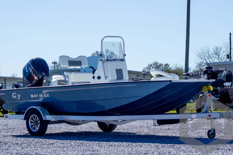 Slide: The Image of 2025 G3 Bay 19 GX boat on trailer, parked outdoors. - 3