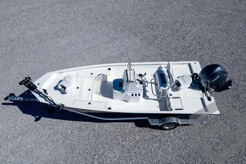 Slide: The Image of 2025 G3 Bay 19 GX boat on trailer, aerial view, gravel background. - 30