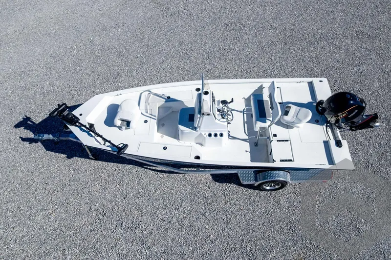 Slide: The Image of 2025 G3 Bay 19 GX boat on trailer, aerial view, parked on gravel surface. - 39