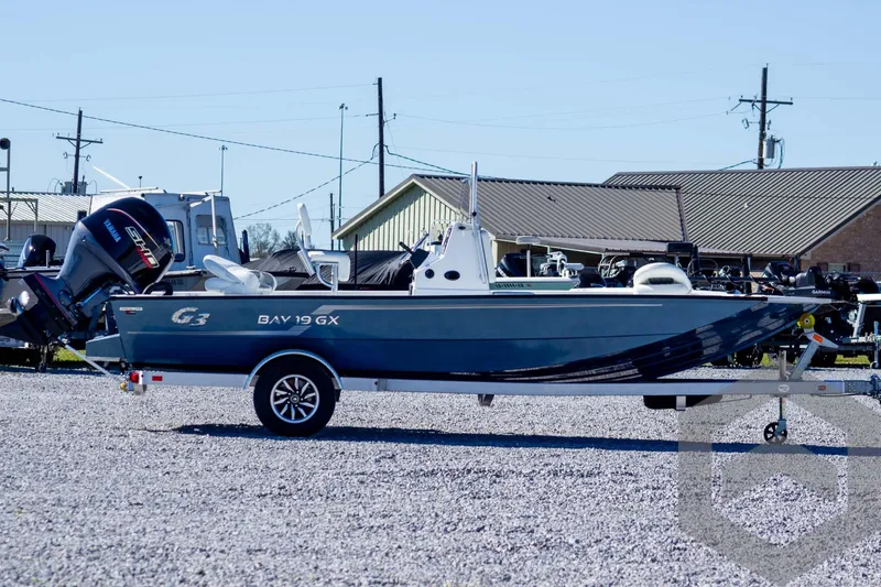 Slide: The Image of 2025 G3 Bay 19 GX boat on trailer, parked outdoors. - 4