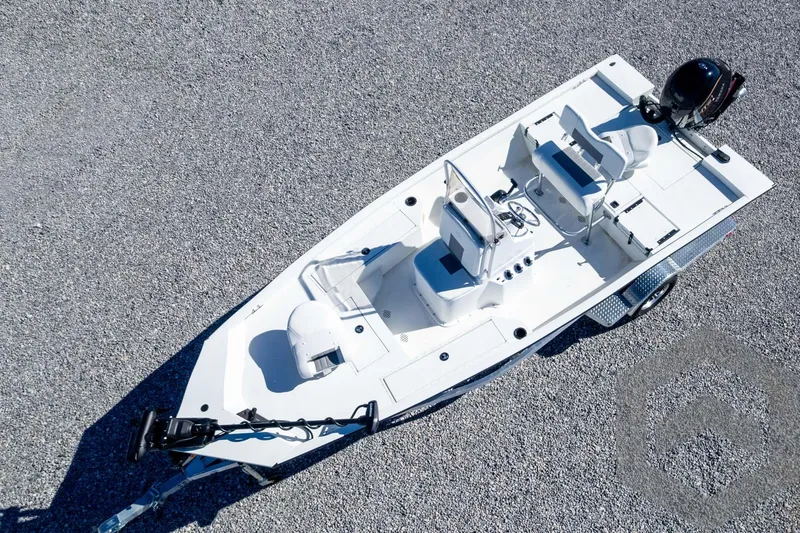 Slide: The Image of 2025 G3 Bay 19 GX boat on trailer, aerial view, parked on gravel surface. - 40