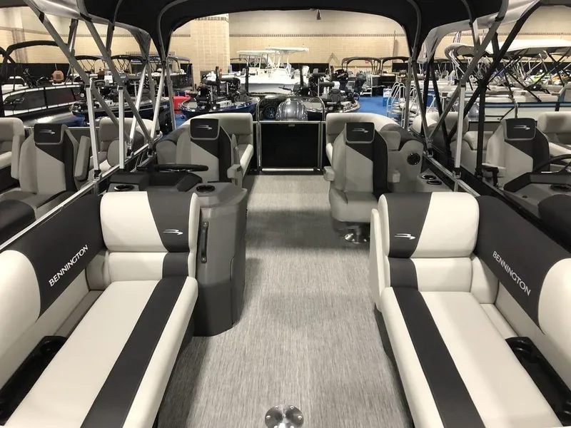Slide: The Image of 2025 Bennington S Quad Bench 22 SSR pontoon boat interior with spacious seating and modern design. - 2