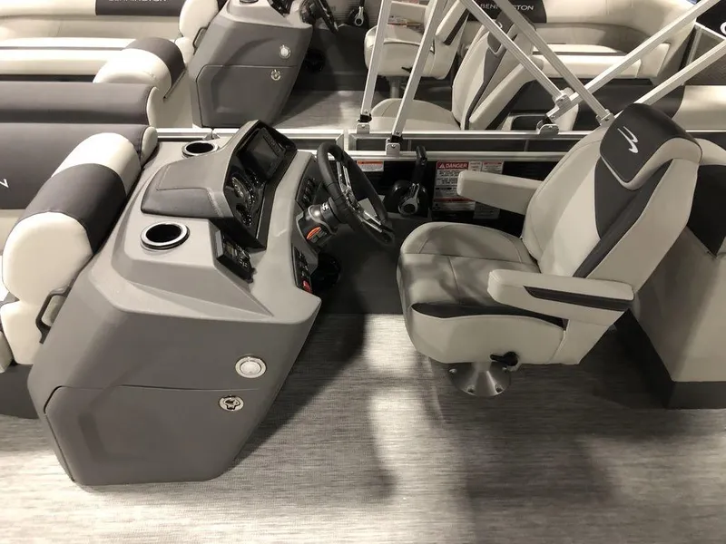Slide: The Image of 2025 Bennington S Quad Bench 22 SSR boat interior with steering console and seating. - 3