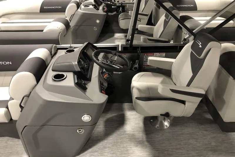 Slide: The Image of 2026 Bennington S Quad Bench 22 SSR SPS boat interior with helm and seating. - 7