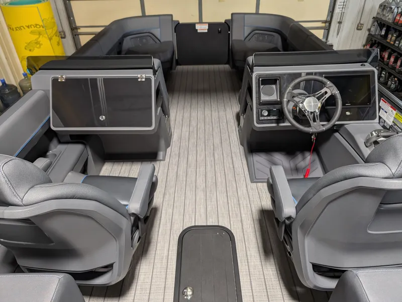 Slide: The Image of 2025 Manitou Explore Dual Engine interior with modern seating and steering console. - 11