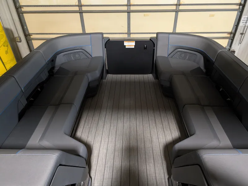 Slide: The Image of Interior of 2025 Manitou Explore Dual Engine boat with spacious seating. - 12