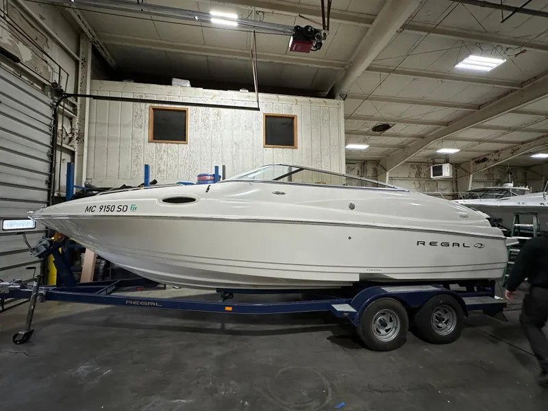 Slide: The Image of 2001 Regal 2350 LSC boat on trailer in indoor storage facility. - 0