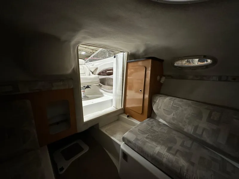 Slide: The Image of Interior cabin of a 2001 Regal 2350 LSC boat, featuring seating and storage. - 12