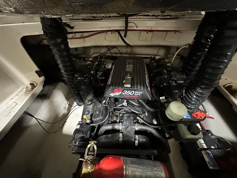 Slide: The Image of Engine compartment of a 2001 Regal 2350 LSC boat with visible components. - 13