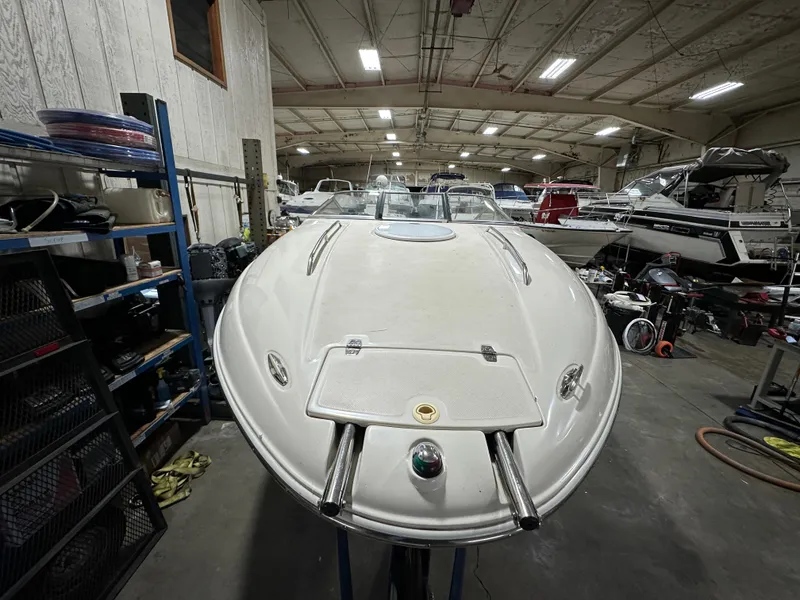 Slide: The Image of 2001 Regal 2350 LSC boat in a storage facility, surrounded by other boats and equipment. - 2