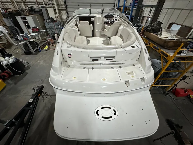 Slide: The Image of 2001 Regal 2350 LSC boat in a workshop, rear view showing spacious deck and seating. - 3