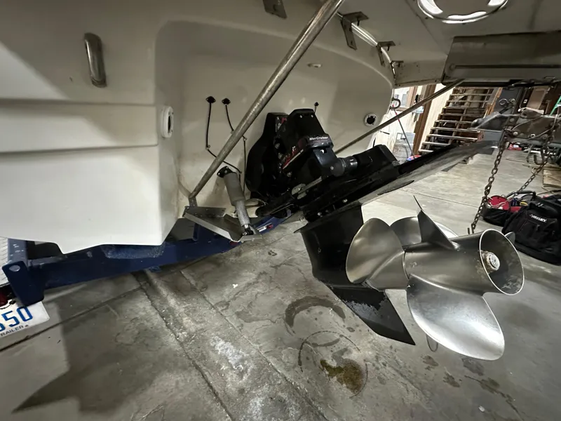 Slide: The Image of 2001 Regal 2350 LSC boat stern with propeller in a garage setting. - 5
